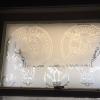 Custom design etched vinyl on glass window.