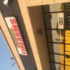 Illuminated capsule sign and vinyl window graphics.
